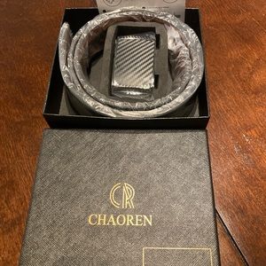 Black lift up click buckle belt in cool gift packaging. Adjustable medium.